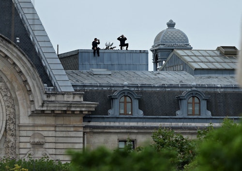 French security on rooftops and rivers overlooking Paris