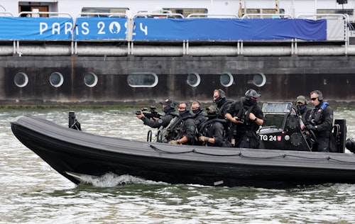 French security on rooftops and rivers overlooking Paris