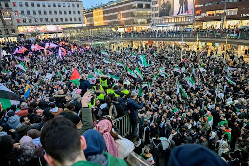 Supporters hoist flags at Syrian embassies abroad